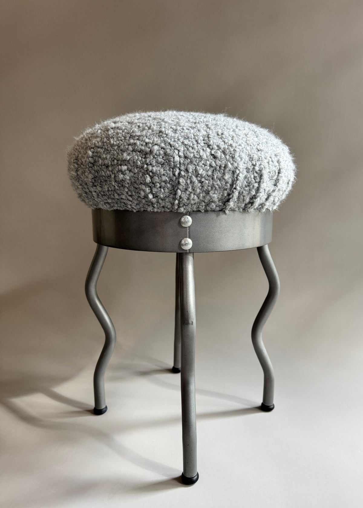 Vintage 1995 IKEA Uri stool by Swedish designer Per Ivar Ledang, featuring a sculptural metal frame and textured grey seat.