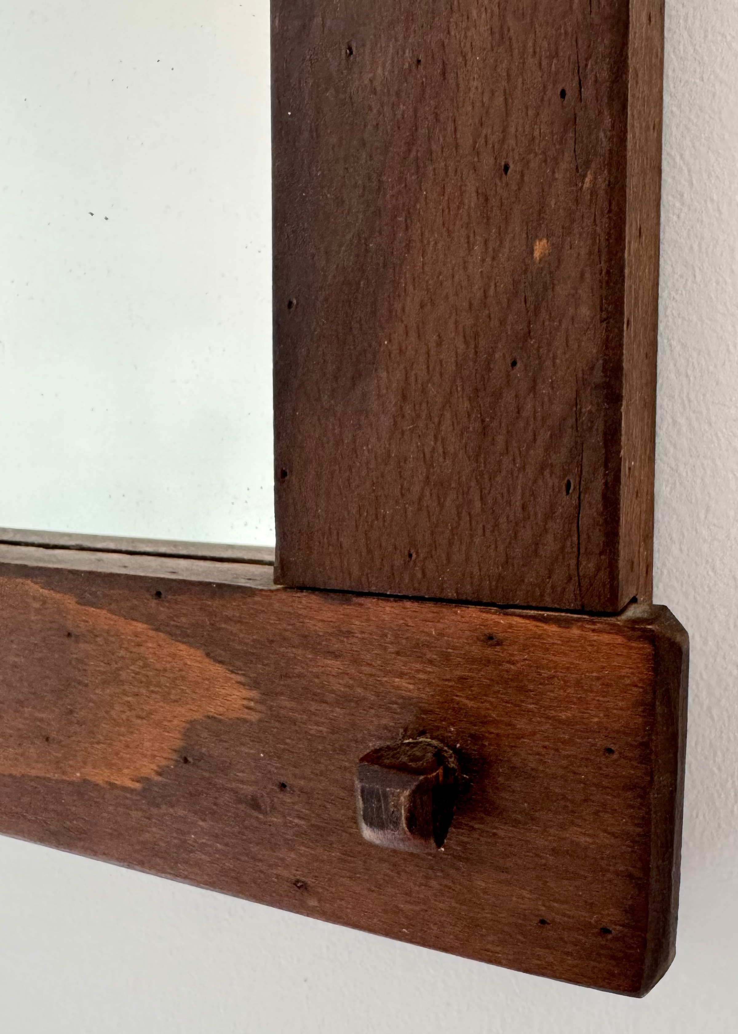 Vintage timber wall mirror with exposed joinery and warm wood patina
