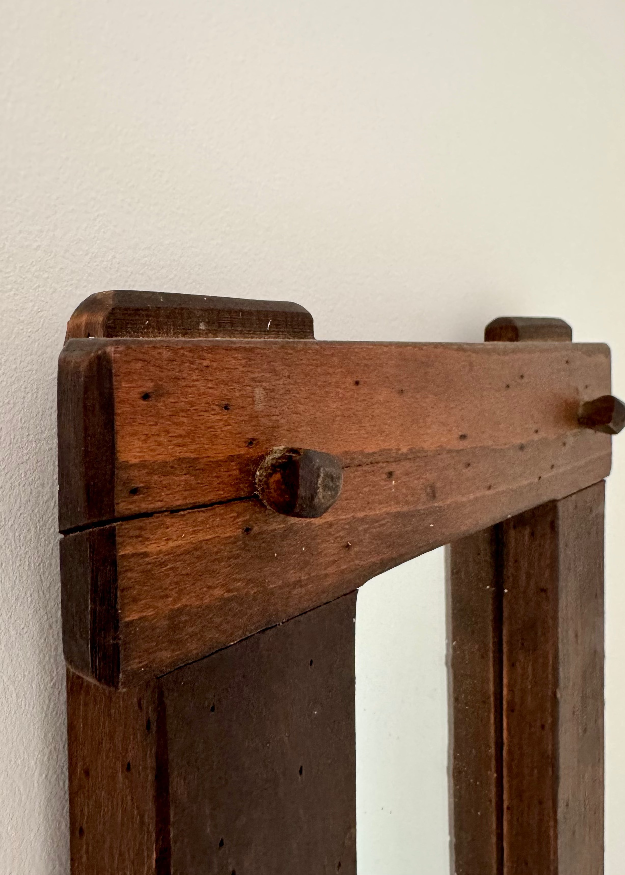 Vintage timber wall mirror with exposed joinery and warm wood patina