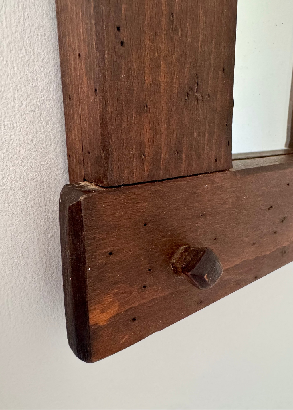 Vintage timber wall mirror with exposed joinery and warm wood patina