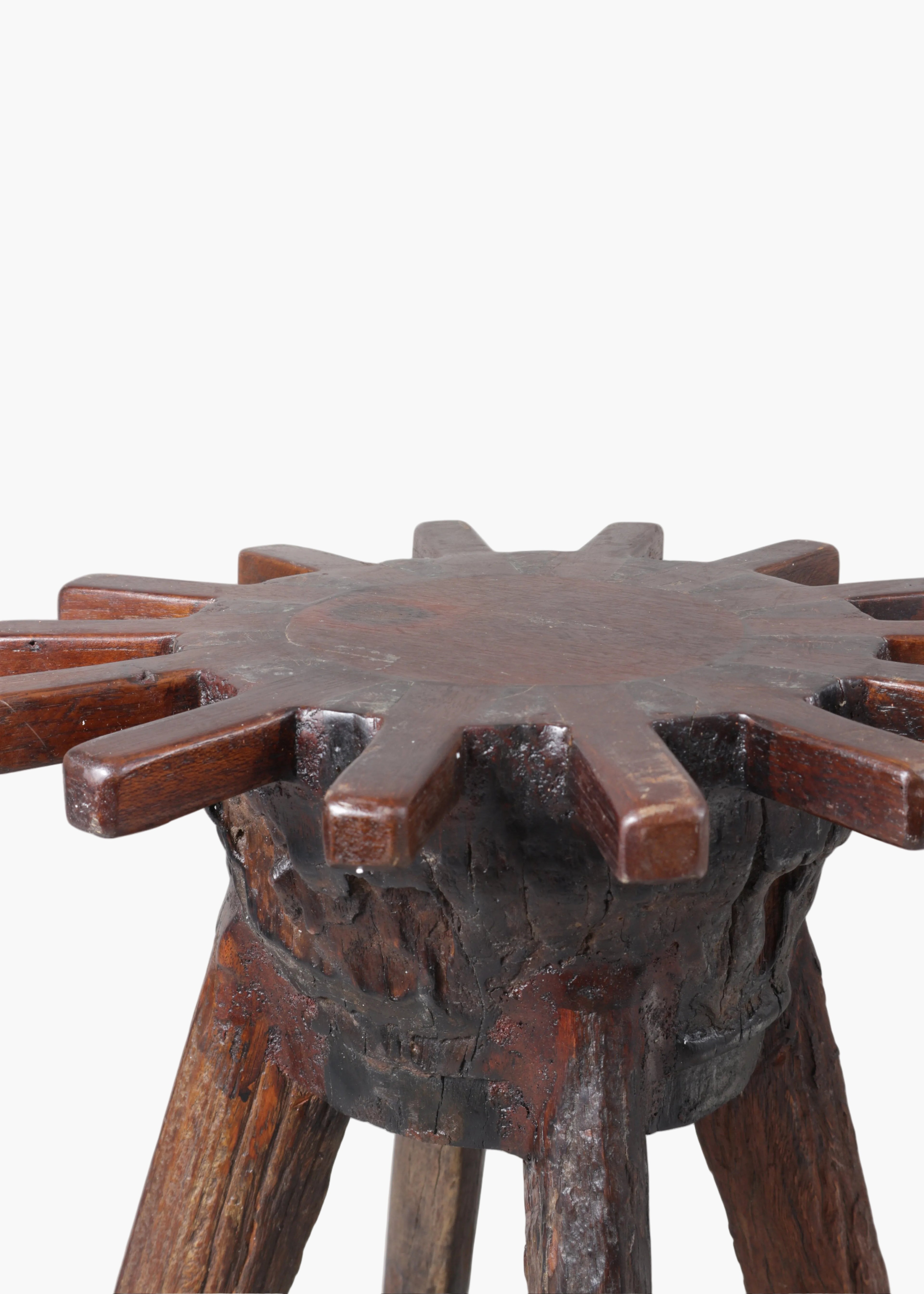 hand carved brutalist primitive french wooden stools with sunburst tops and patina