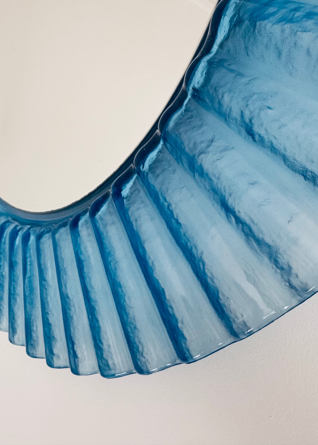 Vintage Italian 1970s blue fluted acrylic wall mirror with circular form.