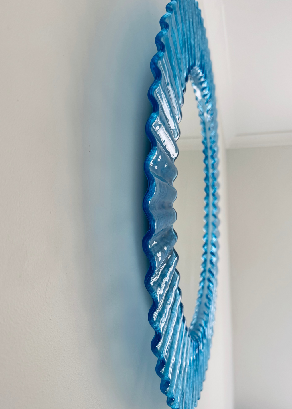 Vintage Italian 1970s blue fluted acrylic wall mirror with circular form.