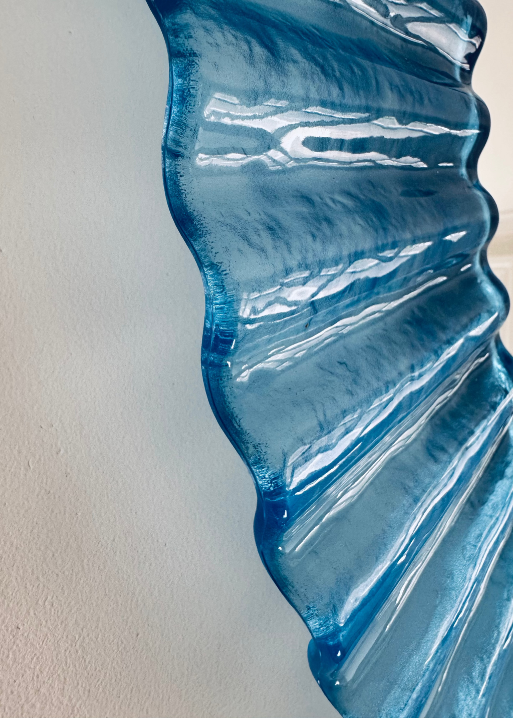 Vintage Italian 1970s blue fluted acrylic wall mirror with circular form.