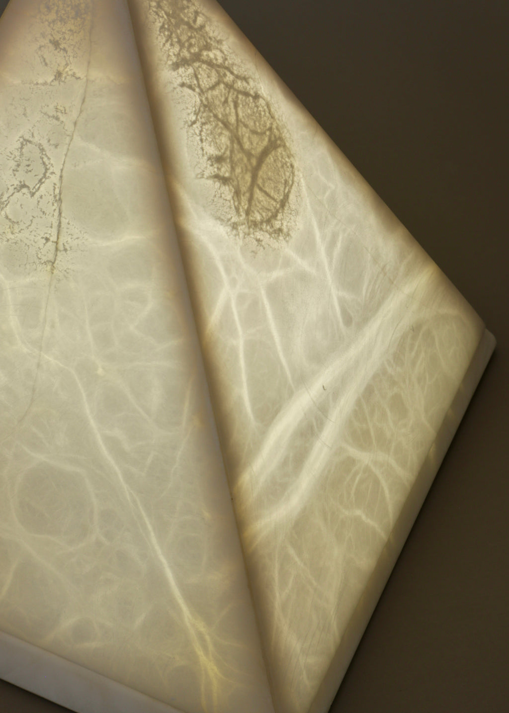 Vintage alabaster pyramid lamp emitting soft ambient light