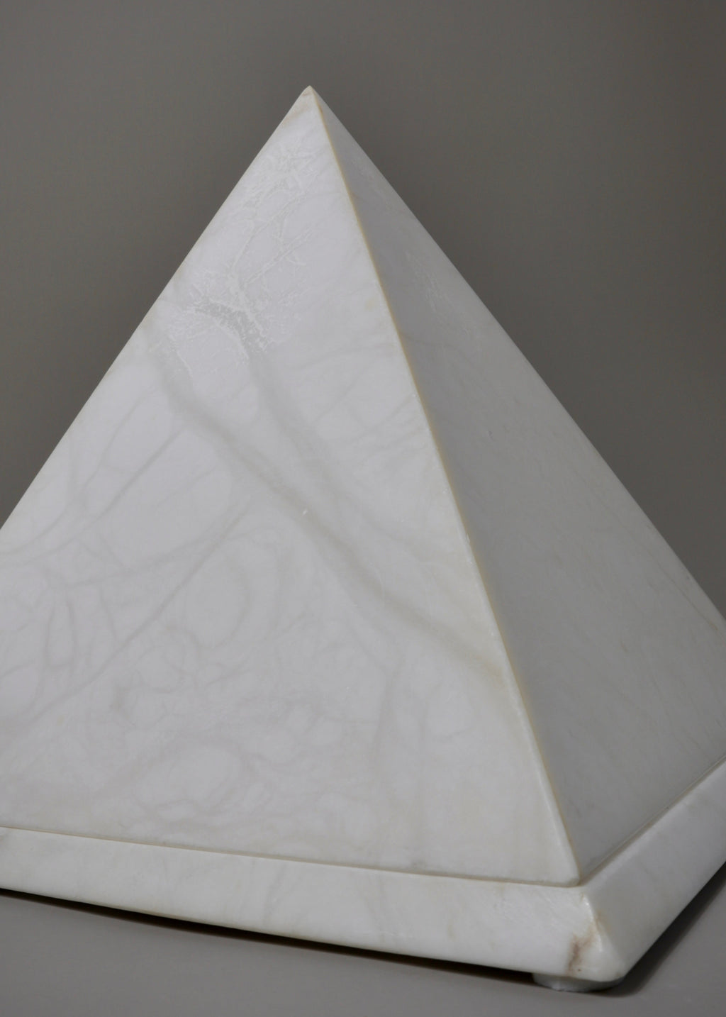 Vintage alabaster pyramid lamp emitting soft ambient light