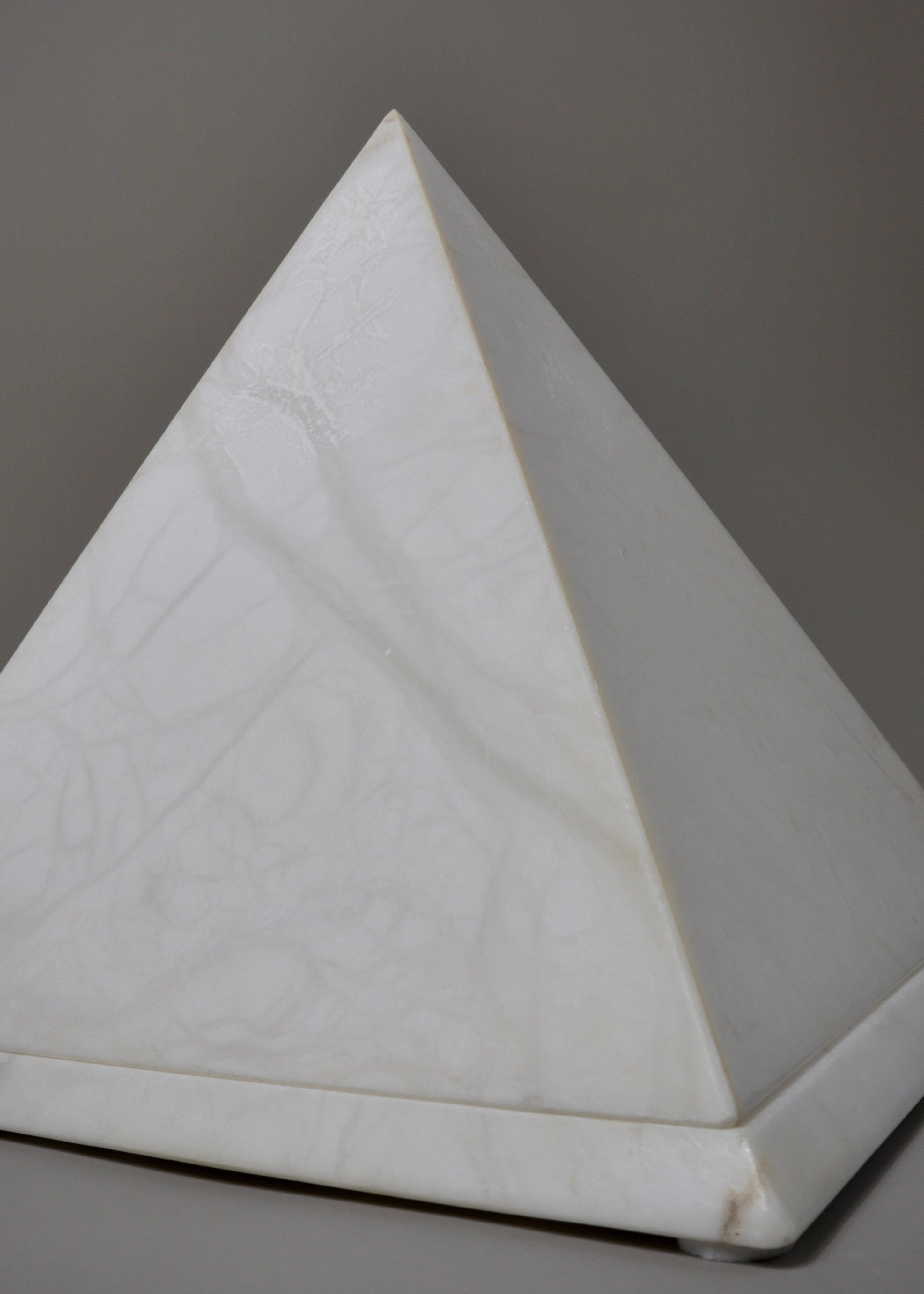 Vintage alabaster pyramid lamp emitting soft ambient light