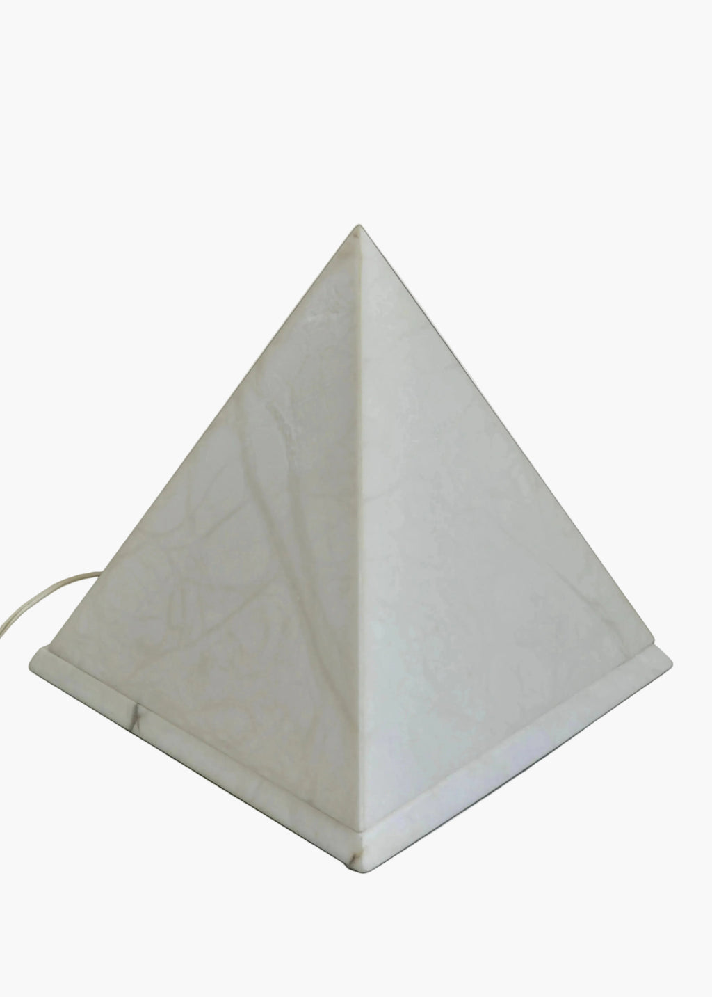 Vintage alabaster pyramid lamp emitting soft ambient light