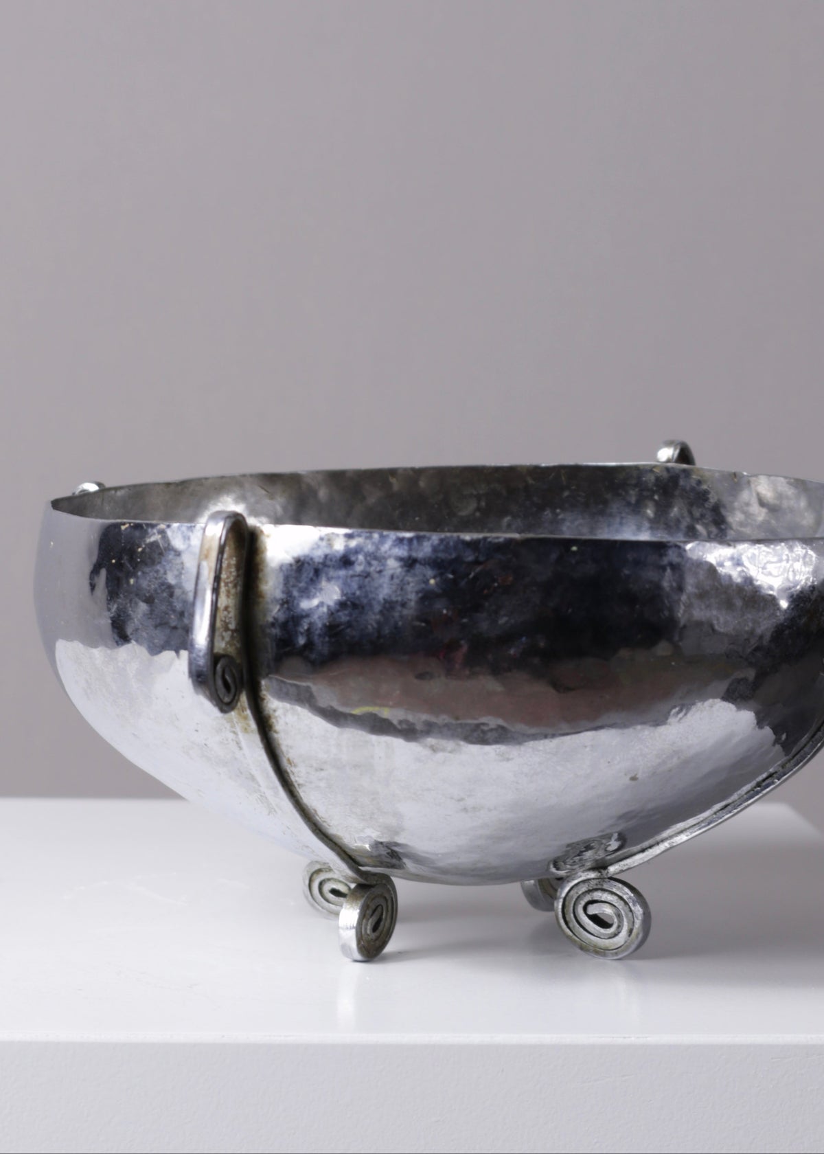 Detail of the irregular hammered texture across the bowl's silver-plated surface.