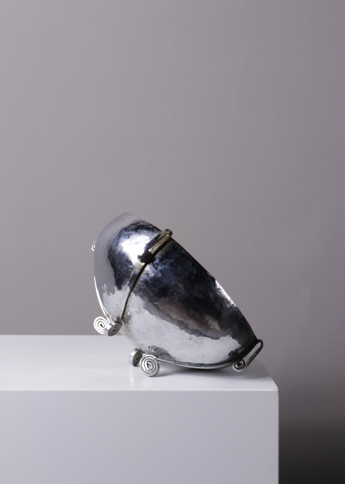 Detail of the irregular hammered texture across the bowl's silver-plated surface.