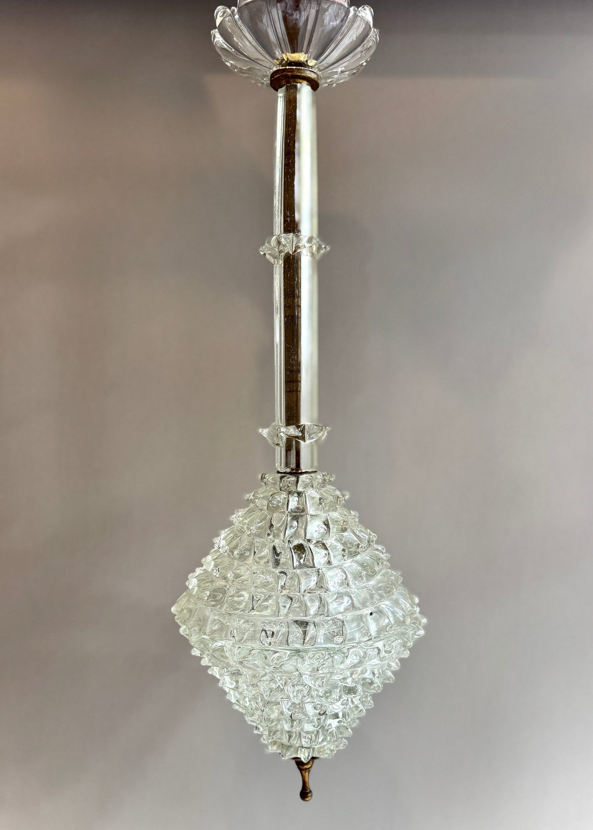 Full view of a vintage Italian rostrato glass pendant in the manner of Barovier & Toso, with a long metal stem and sculptural glass shade.