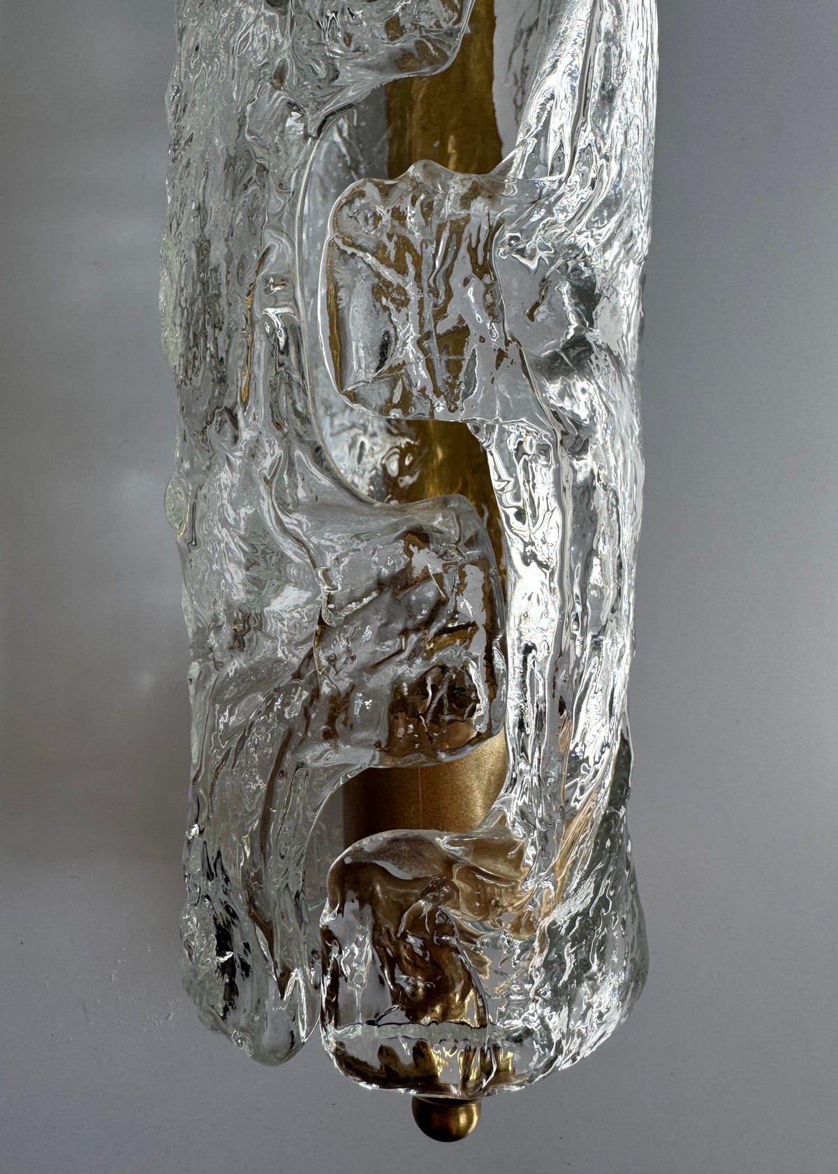 Close-up of the textured ice glass surface on a vintage Italian wall sconce.