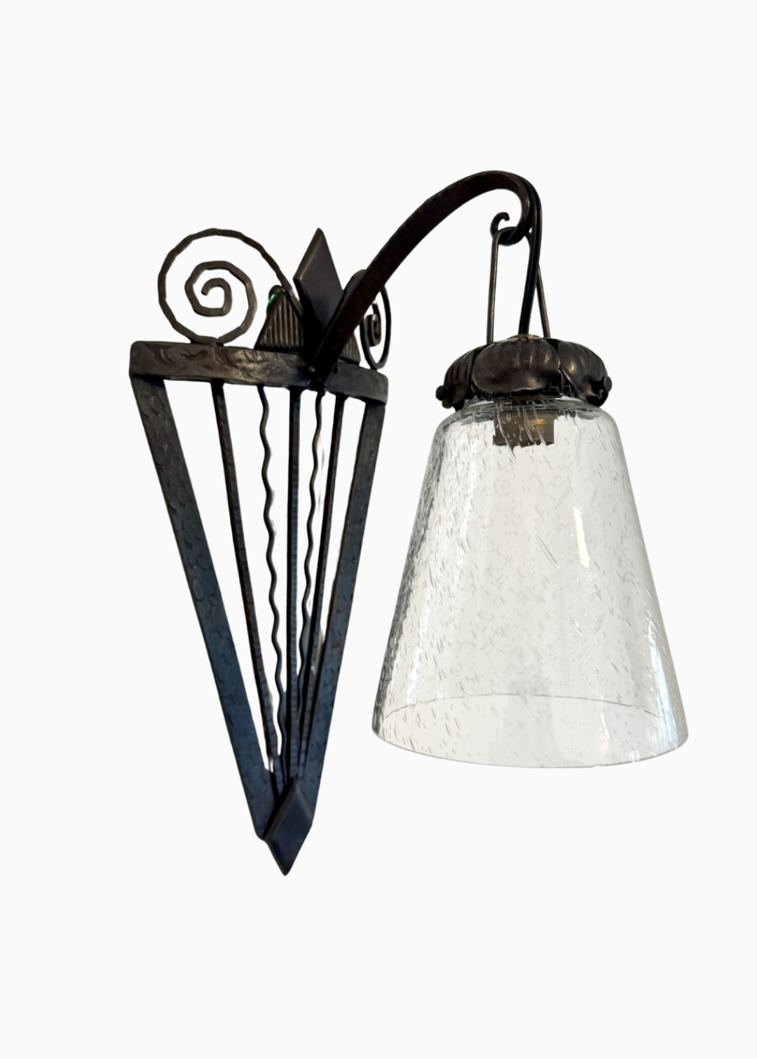 Pair of French Art Deco wrought-iron wall sconces with spiral scrollwork and textured glass shades, circa 1930s.