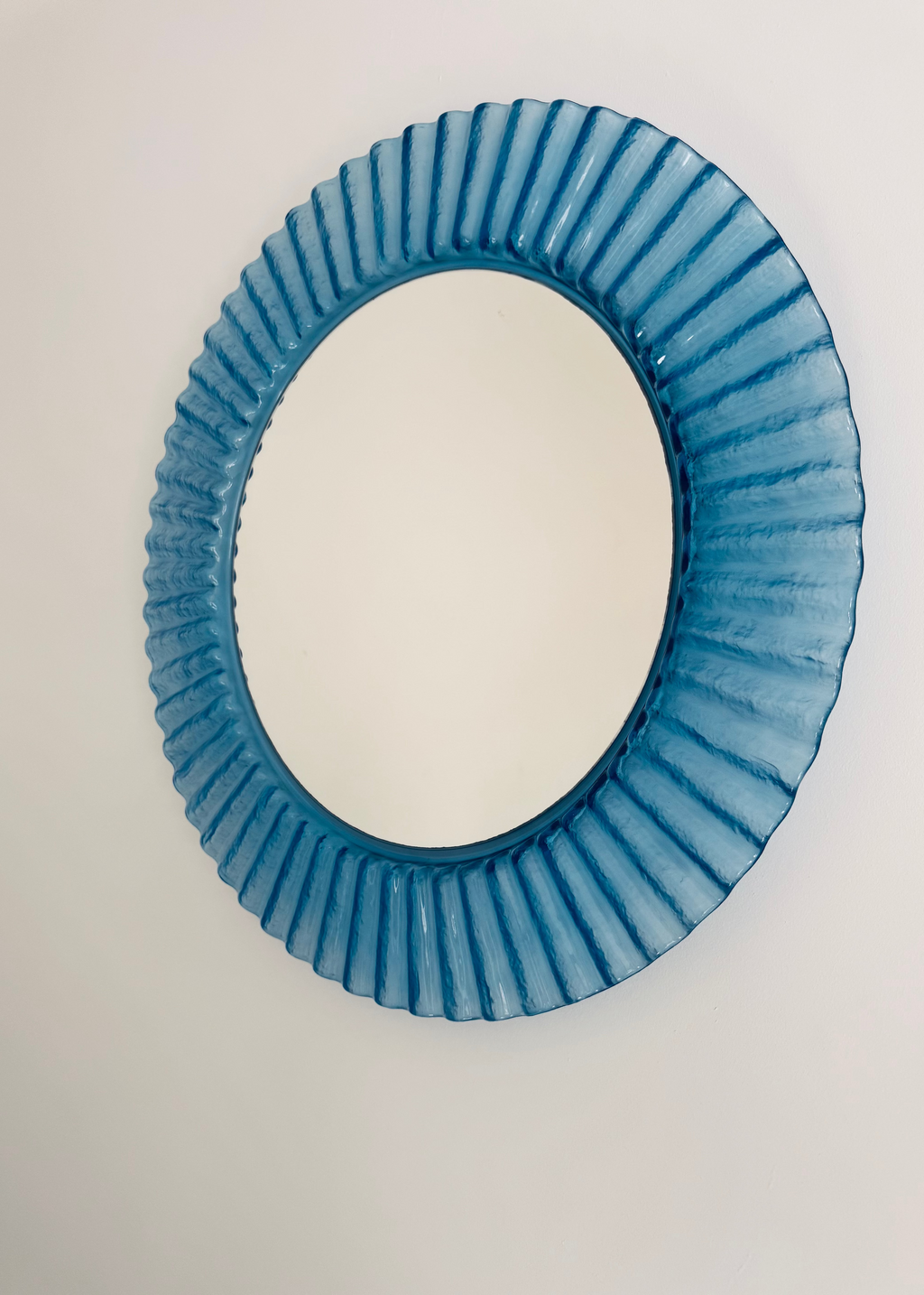 Vintage Italian 1970s blue fluted acrylic wall mirror with circular form.