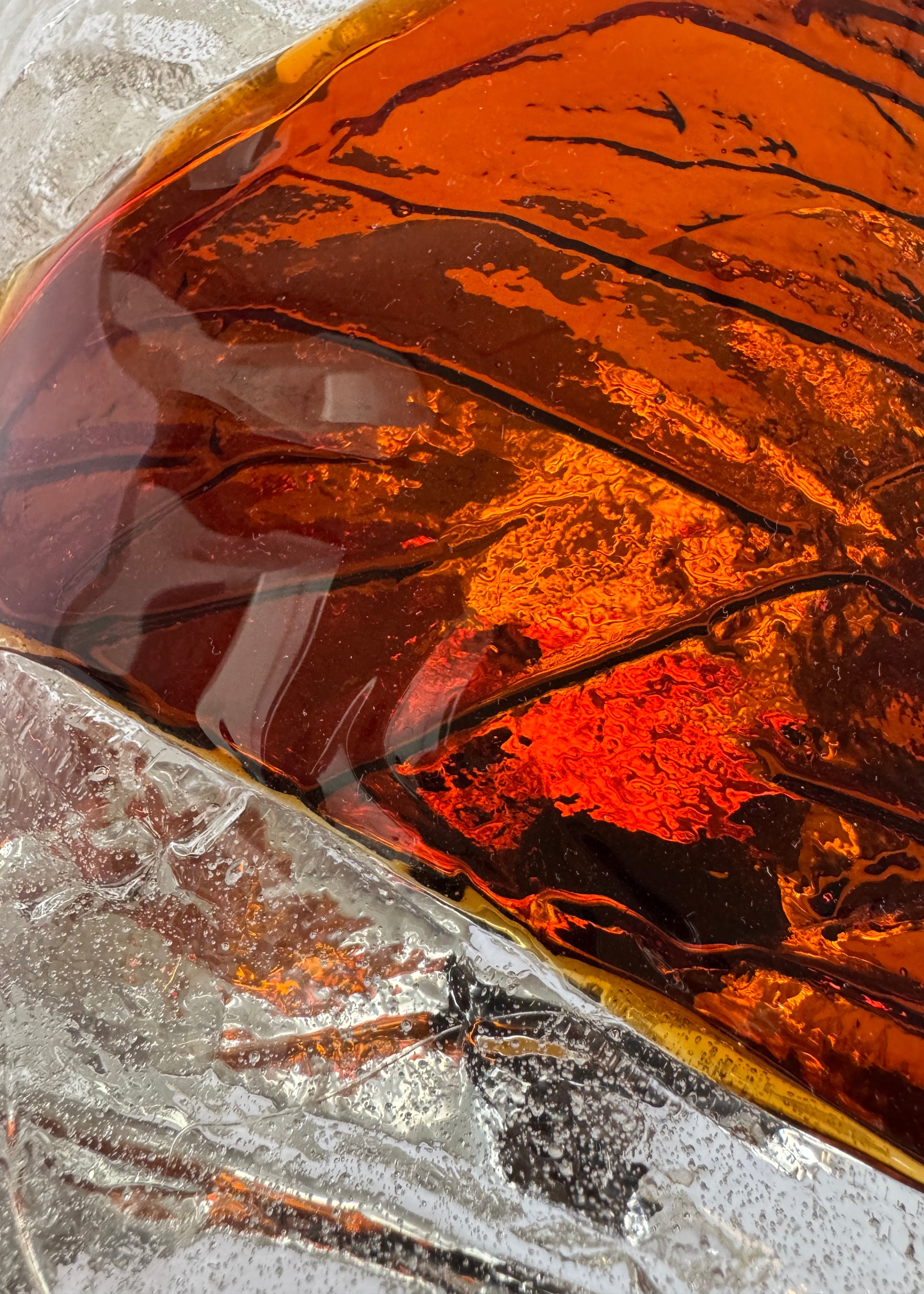 Close-up of amber-colored murano sconce with a textured surface