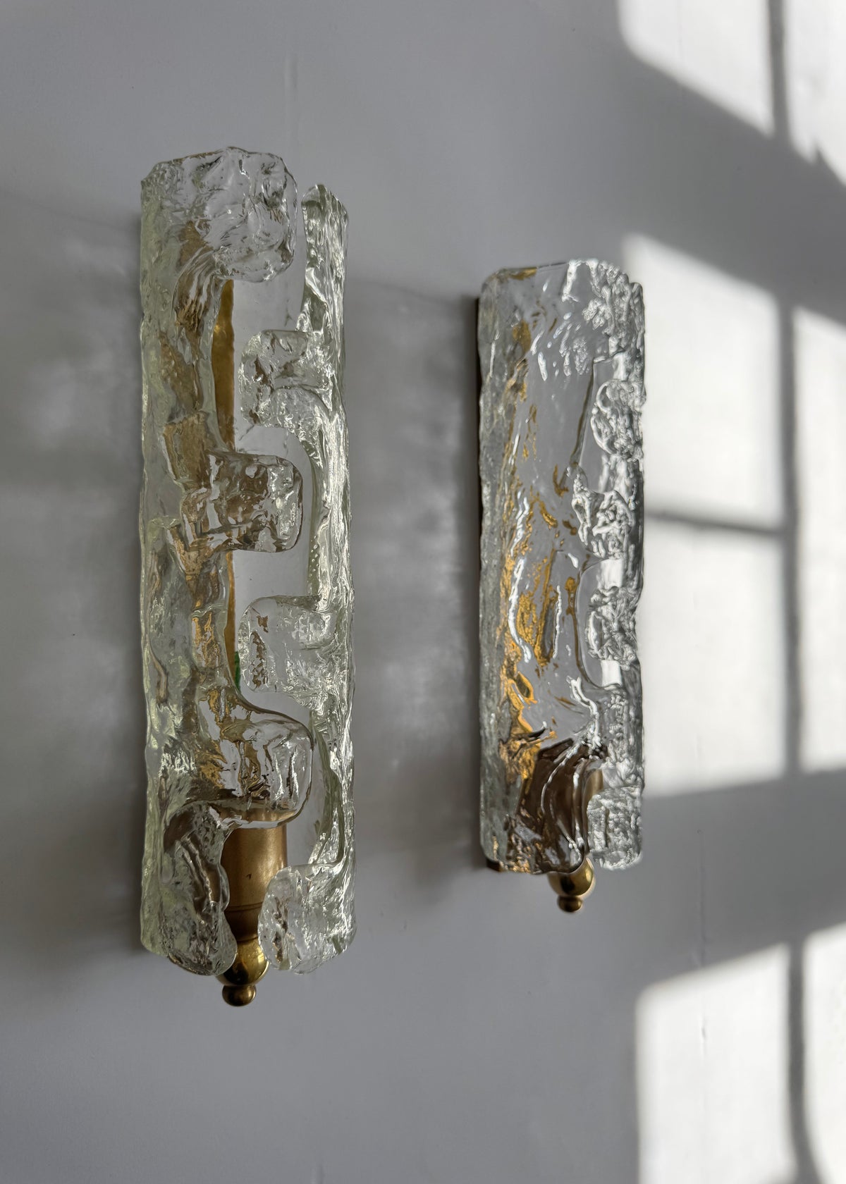 Pair of sculptural vintage Italian wall sconces with textured ice glass that diffuses light when illuminated.