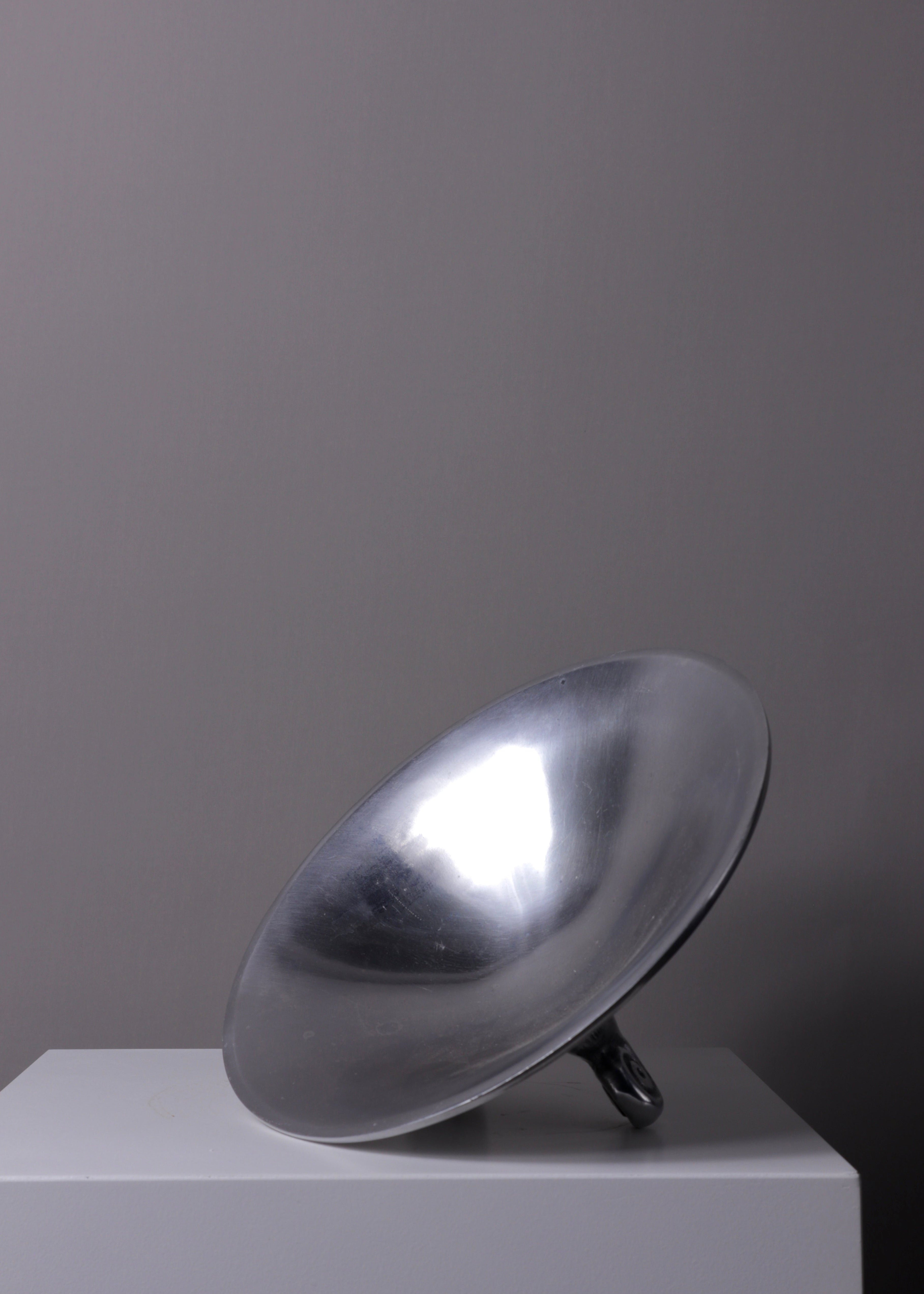 Vintage silver trinket bowl with sculptural scroll feet displayed on a white plinth